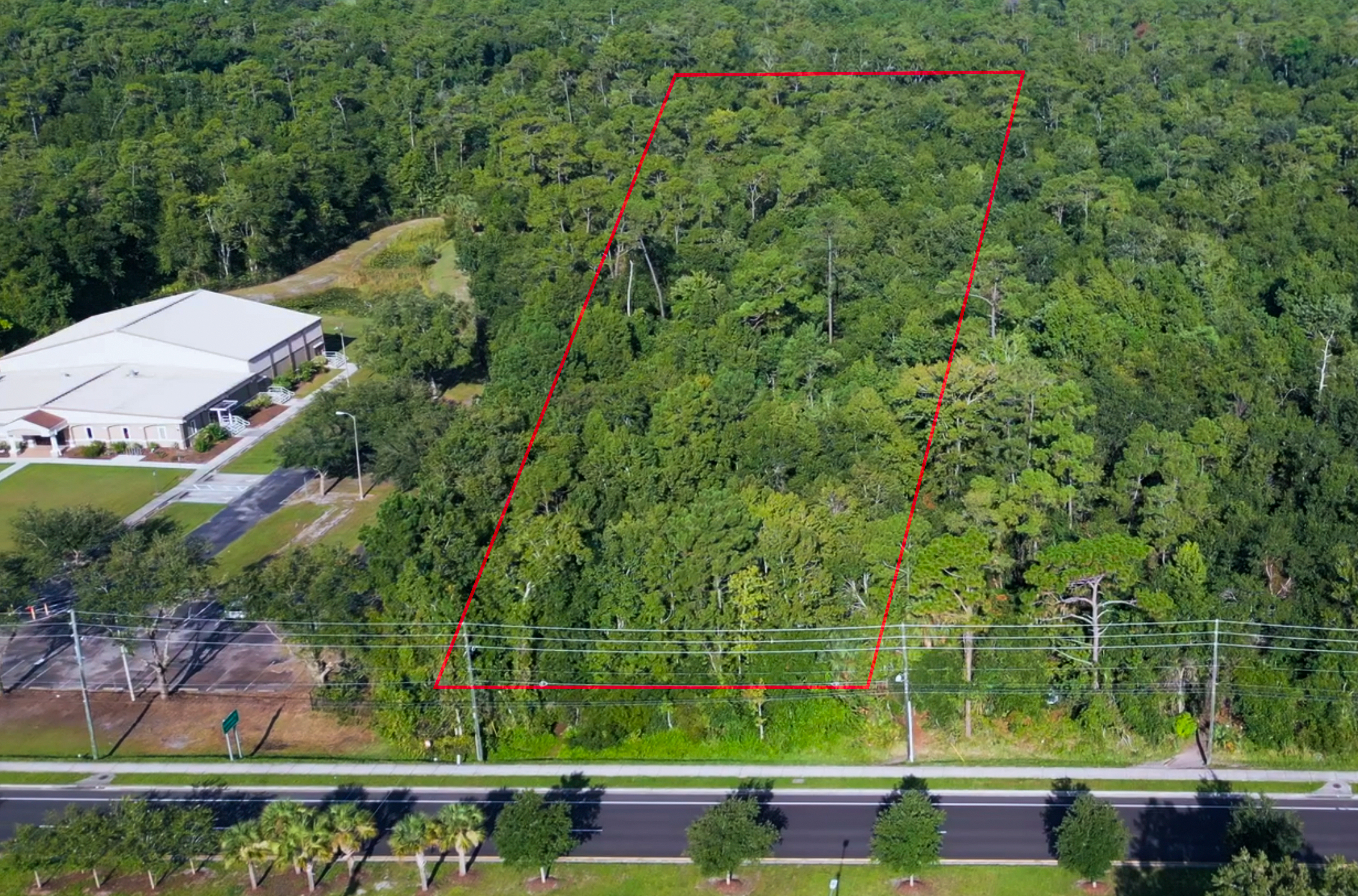 Current aerial view of the wooded Rouse Road parcels with property boundary lines